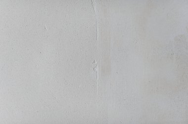 Texture of gypsum plaster of light color. Graphic plaster stains. Rough stone for applying paint. External rough decorative motif