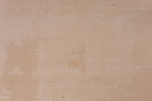 Stucco Wall Background. Close-up of beige gypsum plaster on the wall. The concept of building and repairing a house. Background.