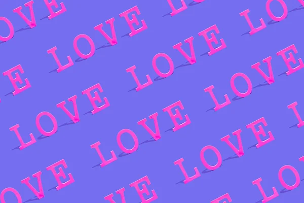 Creative pattern background with colorful Word LOVE. Love or Valentine's Day concept. Flat lay. Vivid pink and purple colors.