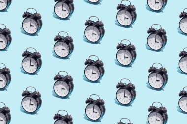 Seamless pattern of black retro alarm clocks  show 3 o'clock. Changing clock from summer time to winter time. Shifting the clock hands back in autumn.