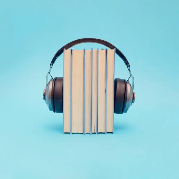 Books with retro headphones. Headset with digital online books stack, idea of podcast listening or electronic learning and study, education, audio books concept.