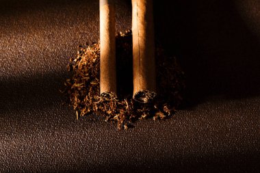 Cigarette. Cigarette, cigarillos and tobacco leaves close-up. Selective focus. Bad habits.