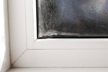 Ice forming on the inside of a window. incorrect window installation, window adjustment, heating problems