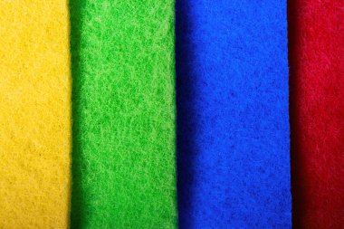 multi-colored different tipes of dishwashing napkins on grey background. The topic of proper dish washing. House cleaning