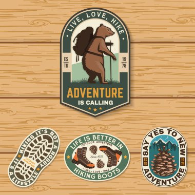 Set of hiking outdoor adventure emblems, patch. Hiking related typographic quote. Design with hiking boot, pine cone, mountains clipart