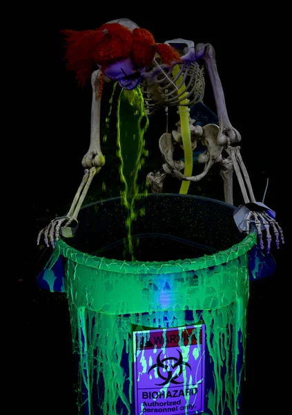 Skeleton seen vomiting up green toxic chemicals into a Hazardous Materials barrel