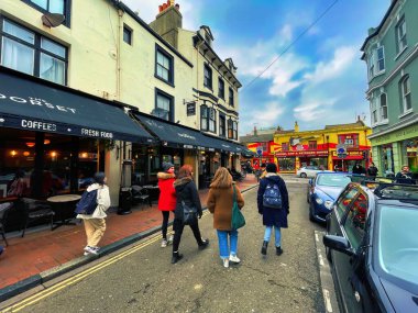 Brighton, United Kingdom - March 04 2022: people passing by stores and shops in vibrant small british street