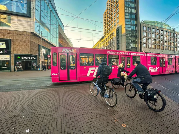 オランダ ハーグ 12月16 2021 自転車は食料品の配達サービスのためのピンクの広告付きトラムを待っています — ストック写真