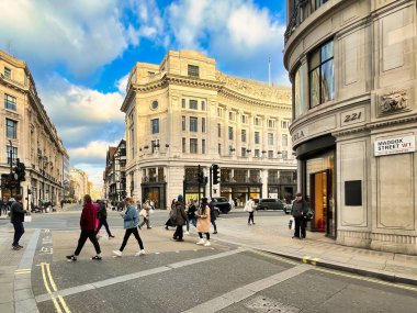 Londra, Birleşik Krallık - 6 Mart 2022: İnsanlar Viktorya dönemi binaları ve tipik İngiliz otobüsleriyle ünlü kral naibi caddesinde alışveriş yapıyorlar.