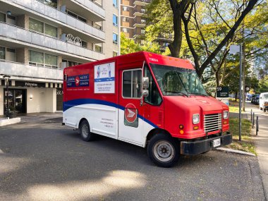 toronto, canada - 24 October 2022: a post canada mail truck unloading in front of an apartment building