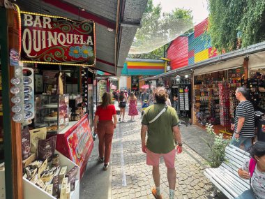 buenos aires, argentina - 29 October 2022 : tourists walking around the colorful and popular la boca neighborhood with shops and stores