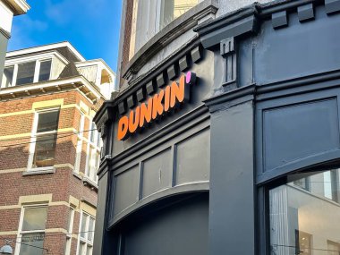 The Hague, netherlands - january 23 2022: store front and sign of a store of dunkin' donut fast food chain clipart