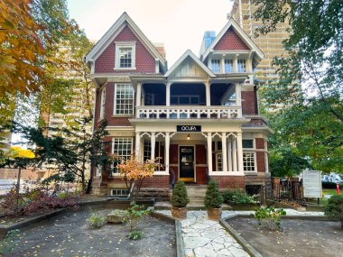 toronto, canada - 24 October 2022: an old historic victorian mansion or luxury home with garden in the middle of the city