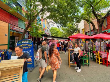 buenos aires, argentina - 29 October 2022 : tourists walking around the colorful and popular la boca neighborhood with shops and stores