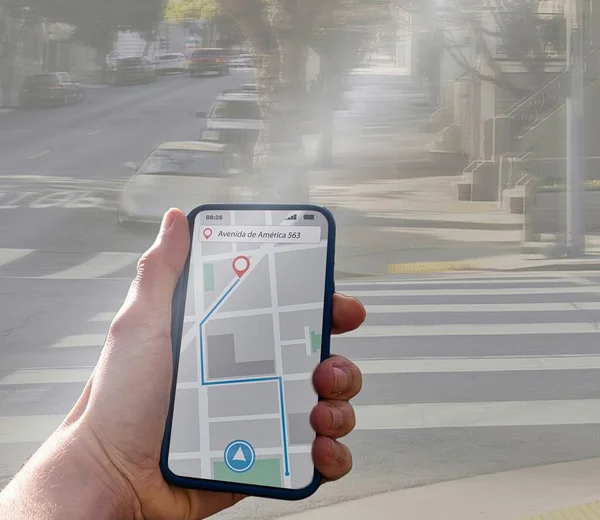 stock image person is walking on a city sidewalk with a navigation on a smartphon