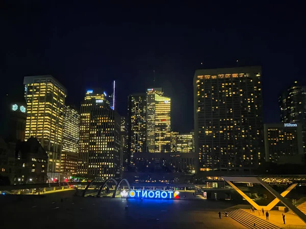 Toronto, Canada - 24 October 2022: looking up from street level and view of skyscrapers at night in the city