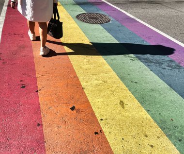 toronto, canada - 24 October 2022: person at pedestrian crossing painted in rainbow colors on gay church street