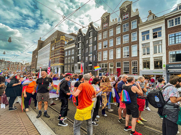 The Hague, Netherlands - 23 August 2021: many people participate to a pride walk in the center of historic amsterdam