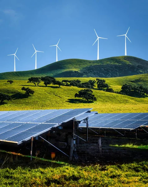 Stock image energy transition to green energy wind turbines and solar power.