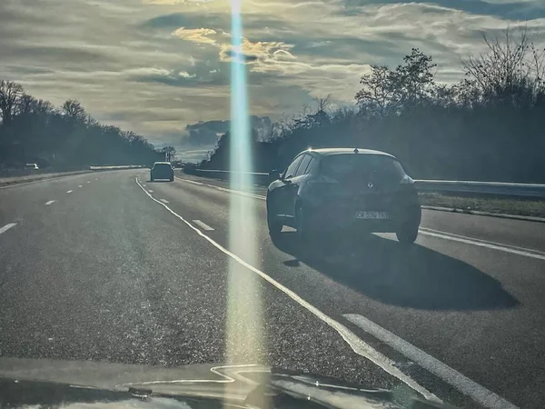 stock image bourg en bresse, france - december 28 2022: cars and trucks are driving on a french highway with low sun light