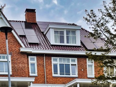 voorburg, Netherlands - June 19 2022: modern dutch home with solar panels on the roof clipart