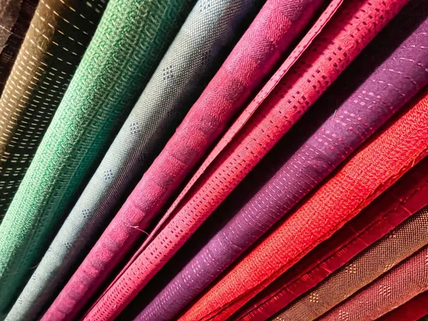 Stock image colorful rolls of different fabrics used at a sewing factory