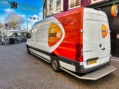 den haag, netherlands - january 23 2022: a delivery truck of delivery organisation post.nl on a city street