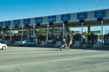 buenos aires, Argentina - 27 October 2022: cars and a motorcycle driving on highway and arriving at a toll station