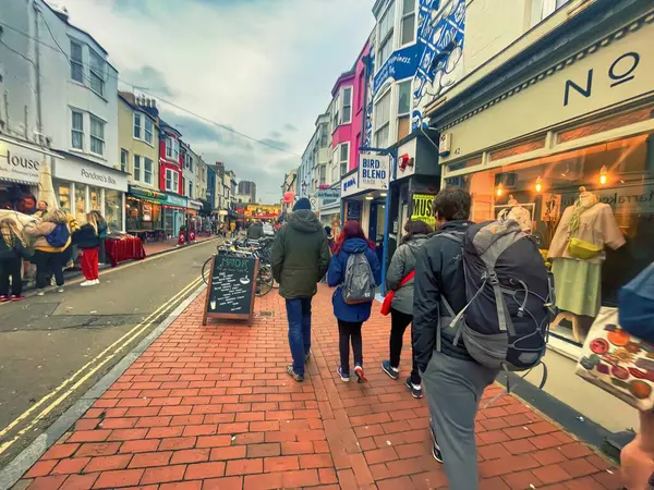 Brighton, United Kingdom - March 04 2022: people passing by stores and shops in vibrant small british street