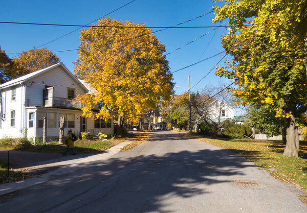 gananoque, canada - 22 October 2022 : residential neighborhood street with historic houses and trees in fall colors