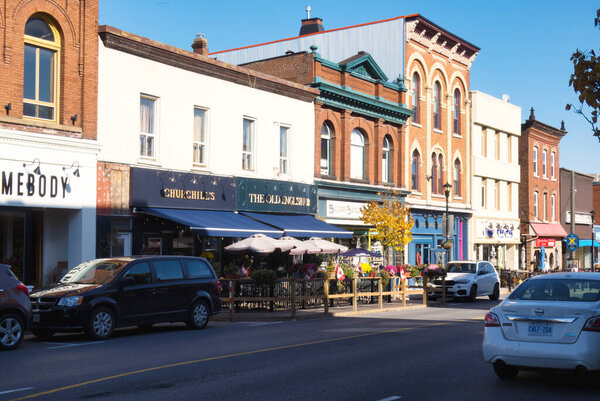 gananoque, canada - 22 October 2022 : restaurant and stores on colorful main street in small town