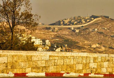 Jerusalem, Israel - November 12 2010 : a view of the big concrete wall separating Israel and Palestine moving over the hills clipart