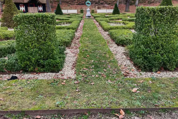 Den Haag, Netherlands - December 20 2021: a classic historic garden with a labyrinth or maze with gravel, hedges and grass