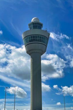 schiphol, netherlands - june 12 2022: outside the terminals of the airport a n high control tower has been placed to control all movement of air traffic