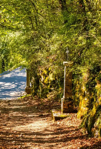 stock image Talloires, France - September 08 2020 : an historic iron cross on a medieval pillar showing the road and direction for pilgrims