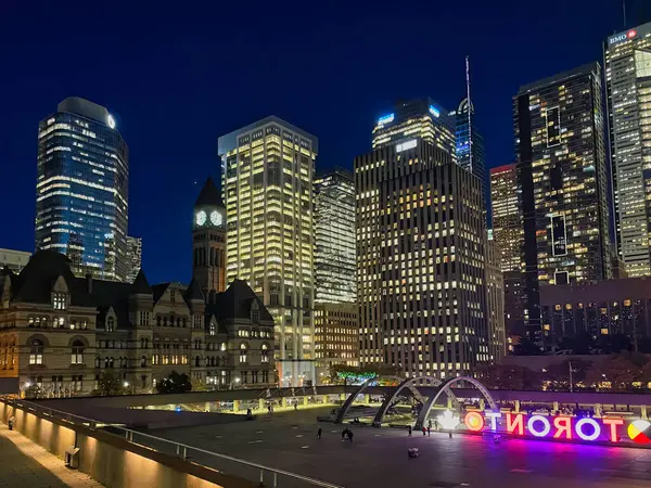 Toronto, Canada - 24 October 2022: looking up from street level and view of skyscrapers at night in the city