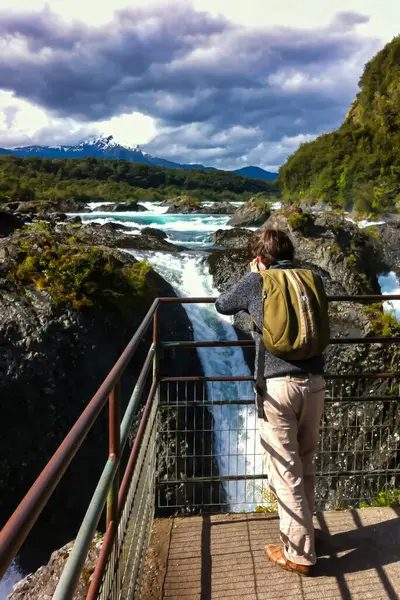 stock image Petrohue, Chile - November 09 2014 : a man is making photos of the landmark the impressive water falls of Petrohue