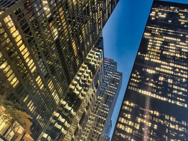 Toronto, Canada - 24 October 2022: looking up from street level and view of skyscrapers at night in the city