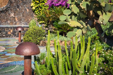 La Palma, Spain - December 04 2013 : a village square on the small island with mosaic stones, cactus trees and metal lamps