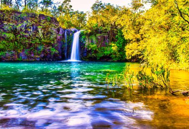 Puerto Varas, Chile - November 10 2014 : a romantic and idylllic looking turquoise mountain lake with water fall in the Andes in southern Chile clipart