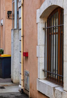 Annecy, Fransa - 21 Eylül 2020: Fransız kasabasında bir ortaçağ tarihi sokak veya ara sokağında metal parmaklıklı pencere