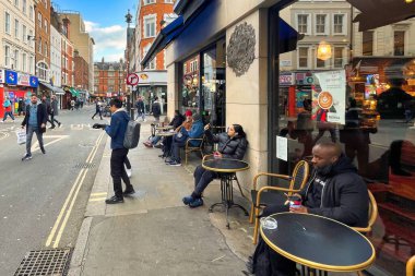 Londra, Birleşik Krallık - 6 Mart 2022: SOHO mahallesinde kaldırımda birçok modern insan ile cadde meşgul