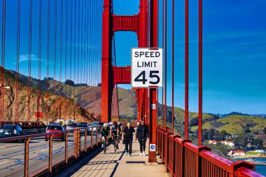 San Francisco, United States - February 12 2020 : tourist and locals visit the famous golden gate bridge on bike or walking clipart