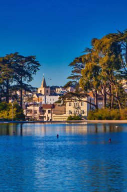 San Francisco, United States - February 14 2013: Almost down the golden gate park towards the pacific ocean. Sprecklers lake is a calm place to unwind. clipart