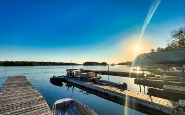 gananoque, canada - 22 October 2022 : saint lawrence river with boats docked and wooden pier in the thousand island regions