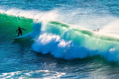 Santa Cruz, United States - January 27 , 2013 : Surf capitol off the US. Only the bravest surfest dare to ride these waves. clipart