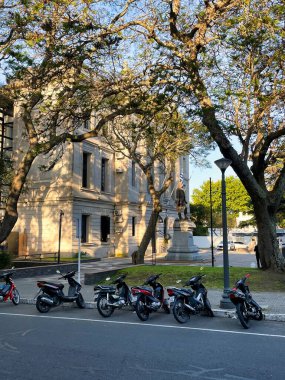 colonia del sacramento, uruguay - november 1 2022: motor cycles parked in the Barrio historica of the colonial UNESCO world heritage site clipart