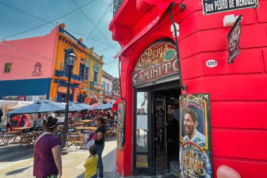 buenos aires, argentina - 29 October 2022 : tourists walking around the colorful and popular la boca neighborhood with shops and stores