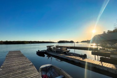 gananoque, canada - 22 October 2022 : saint lawrence river with boats docked and wooden pier in the thousand island regions