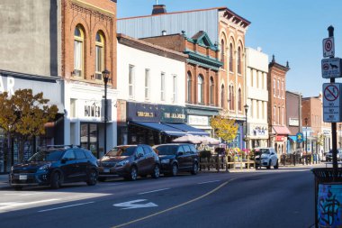 gananoque, canada - 22 October 2022 : restaurant and stores on colorful main street in small town